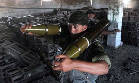 Libyan fighters carrying ammunition from