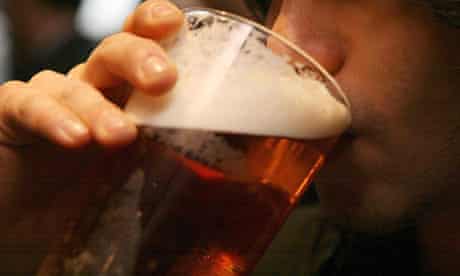Man drinks pint of beer in British pub