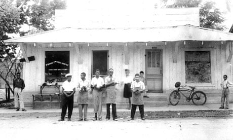 Frank Morris and his employees standing in front of his shoe repair shop