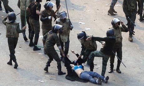 Egyptian army soldiers beating a female protester 