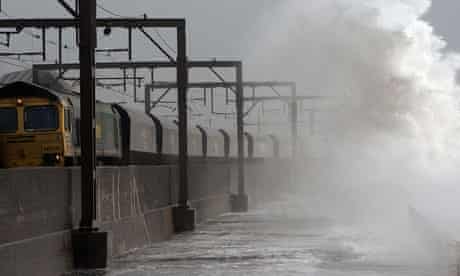 Waves sweep over the railway line in North Ayrshire.
