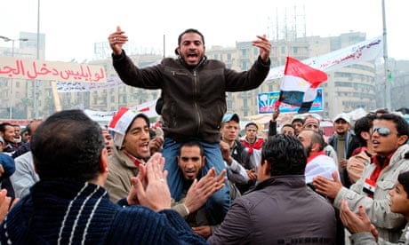 Egyptian anti government protesters shout slogans as they continue their presence in Tahrir square