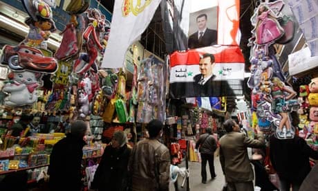Images of Syria's president, Bashar al-Assad, hang in a Damascus market.