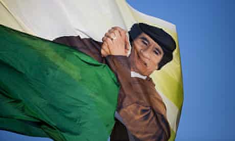 A flag with Muammar Gaddafi's image is flown by his supporters in Tripoli