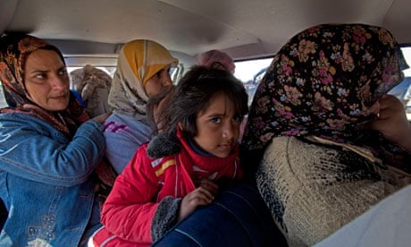 Civilian refugees flee the eastern Libyan town of Ajdabiya