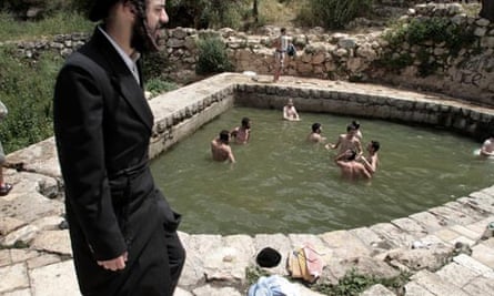 Ultra-orthodox Jewish teenagers swimming in the village spring