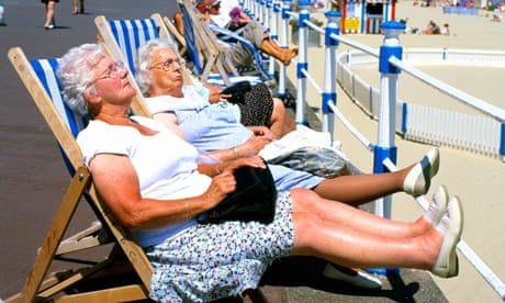 Snoozing in deckchairs at Weymouth beach in Dorset.