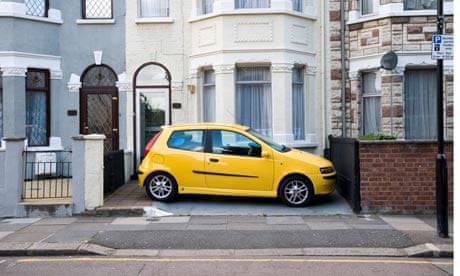 Car parked in front garden of terraced house, London