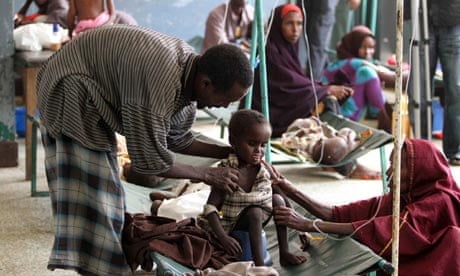MDG : Parents attend to their malnourished child at Banadir hospital in Somalia's capital Mogadishu