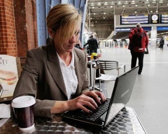 A businesswoman uses a netbook
