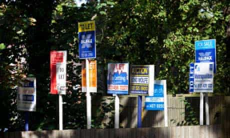 A row of for sale, to let and auction property signs in Birmingham