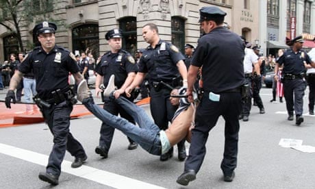 NYPD officers carry away a man during a Wall Street protest.