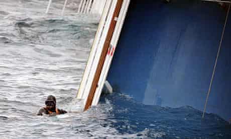 A rescue diver surfaces next to the Costa Concordia in Giglio harbour.