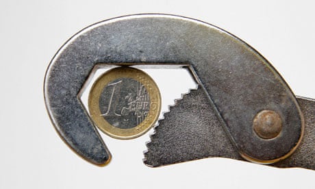 euro coin being held in a wrench