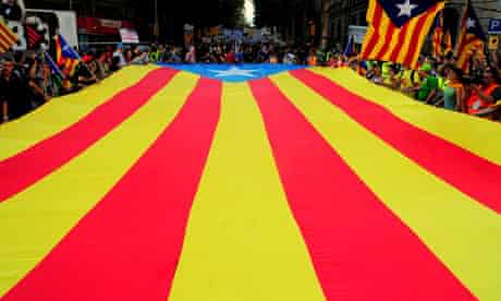 Marchers carry a Catalan flag during a pro-independence rally in Barcelona, in September.