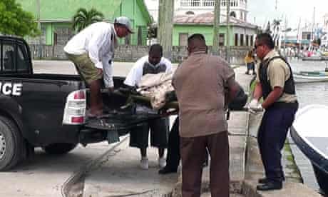 Gregory Faull's body is removed by detectives in Belize following his death.