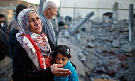 A Palestinian woman cries next to a house destroyed in an Israeli air strike in Beit Lahiya