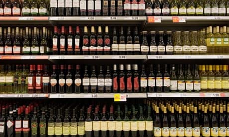 Bottles of cheap red wine on shelves in a budget supermarket in the UK