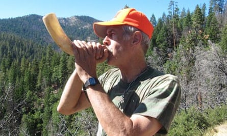 Dan Tichenor blows a cow horn to summon his hounds.