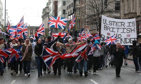Loyalists march in Belfast waving British Union flags
