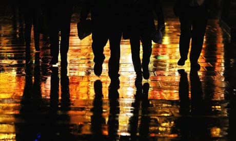 People walk through heavy rain on the South Bank, in London.