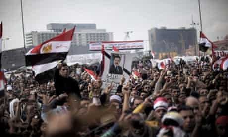 Egyptian anti-government demonstrators stage a symbolic funeral for journalist Ahmed Mohammed Mahmud