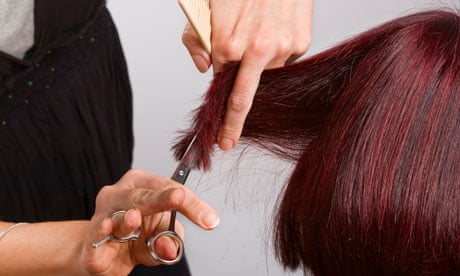 Hairdresser at work cutting customers hair