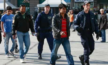 Greek police escort migrants