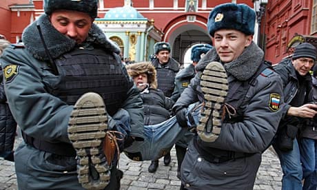 Police detain a protester outside Red Square, Moscow.