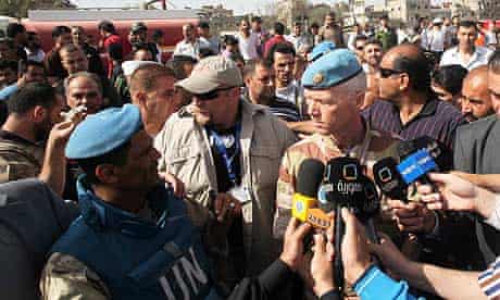 The head of the UN mission, Robert Mood (r), speaks to reporters in Damascus