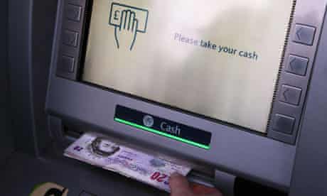 Woman uses cash machine 
