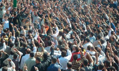 Anti-government protesters shout anti-Assad slogans during the funeral of Sunnis killed near Homs