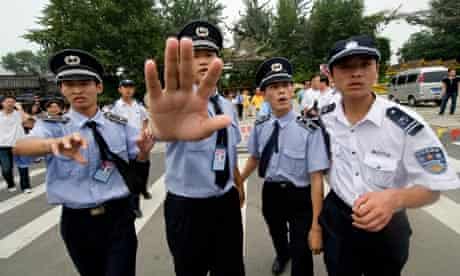 Police stop the media from filming after a Pro-Tibet demo near the Beijing national stadium
