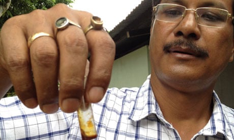 Dr Anuj Baruah holds vial of bhut jolokia oil