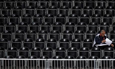 A lone man sits in an empty section of seats inside Earls Court during during a women's volleyball 