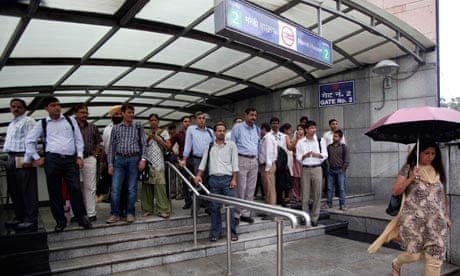 Commuters in Delhi exit a metro station