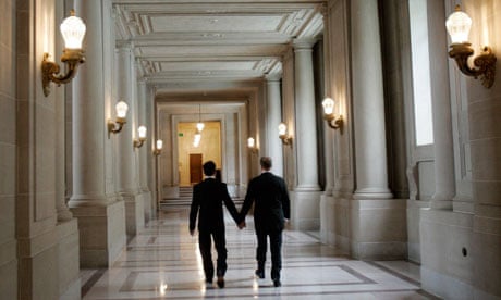 Same-sex couple Hata and Cadena walk a hallway after their wedding ceremony in San Francisco