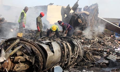 Firefighters work among the wreckage of the Dana Air plane that crashed in Lagos on 4 June 2012