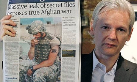 Secrets: Julian Assange holds up a copy of the Guardian reporting the release of the Afghan war logs