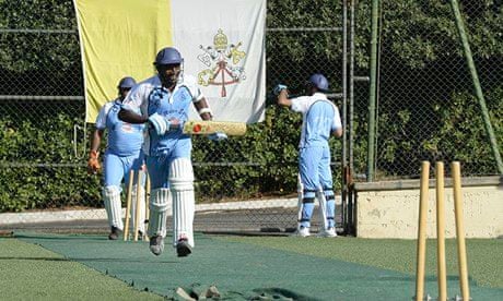 Trainee priests play cricket at the Vatican, with the coat of arms of Saint Peter in the background.