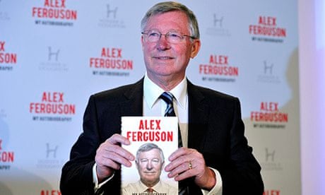Alex Ferguson holding up his book