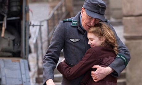 Geoffrey Rush and Sophie Nelisse hug in a scene from The Book Thief