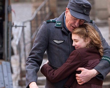 Geoffrey Rush and Sophie Nelisse hug in a scene from The Book Thief