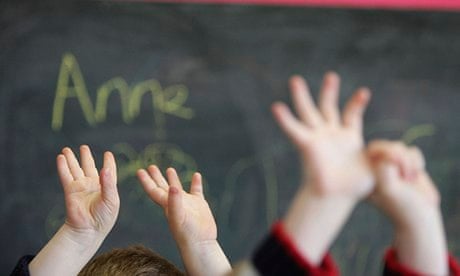 Children wave their hands at a nursery school