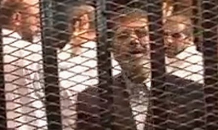 Mohamed Morsi in a cage in a courthouse