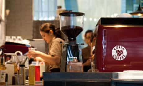 A barista at work in Costa Coffee.