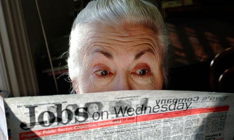 A surprised looking woman pensioner surveys the jobs on offer in her local paper.
