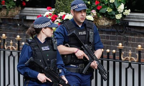 Armed police officers patrol outside The Goring hotel in London