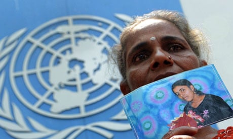 A Sri Lankan Tamil woman holds a portrait of a missing relative