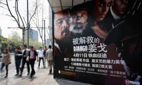 People walk past a poster for Django Unchained outside a cinema in Shanghai
